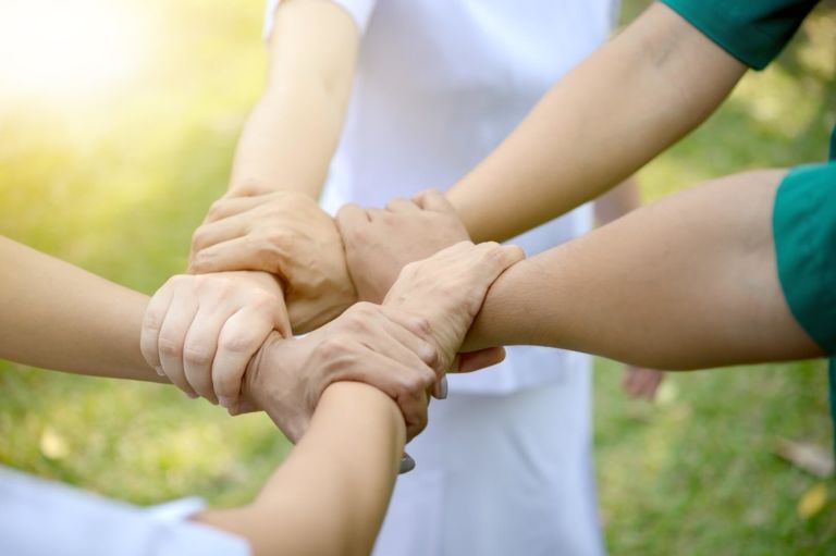 People holding each others hand in support